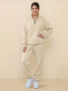 Woman wearing beige ultra-soft and comfy co-ord tracksuit set with zip-up top and relaxed pants.