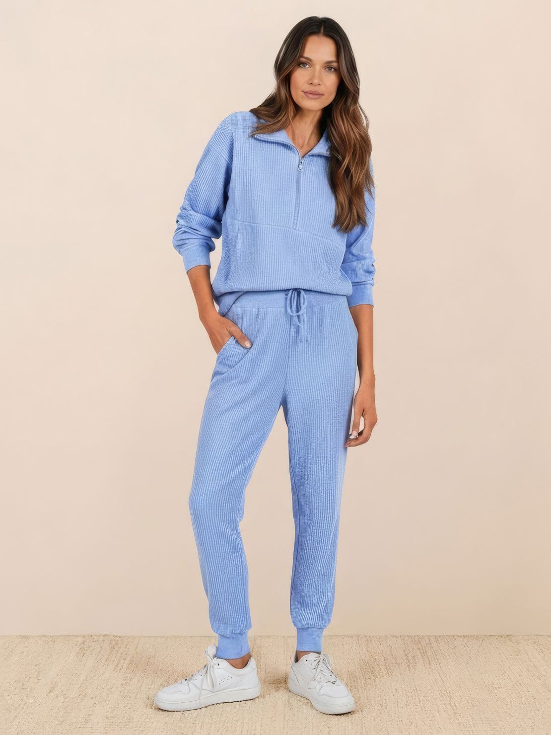 Unisex half-zip pullover and sweatpants set in soft fabric with relaxed fit for casual wear and travel