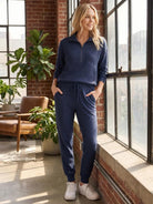 Unisex half-zip pullover and matching sweatpants set in soft fabric for casual comfort