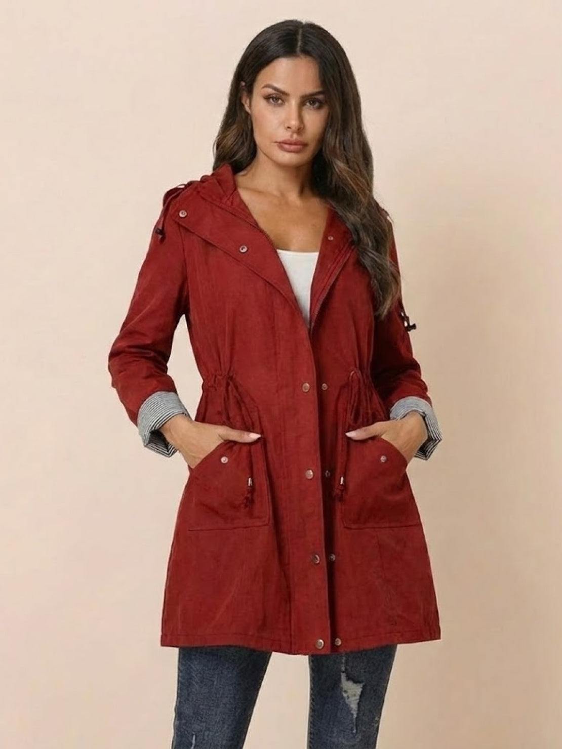 woman wearing red water resistant hooded striped windbreaker jacket with pockets and adjustable waist